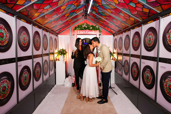 Participants of LG Electronics’ "Love to Laundry" event pose for a commemorative photo in front of LG Electronics’ combination washer-dryer WashTower. (Photo courtesy of LG Electronics)